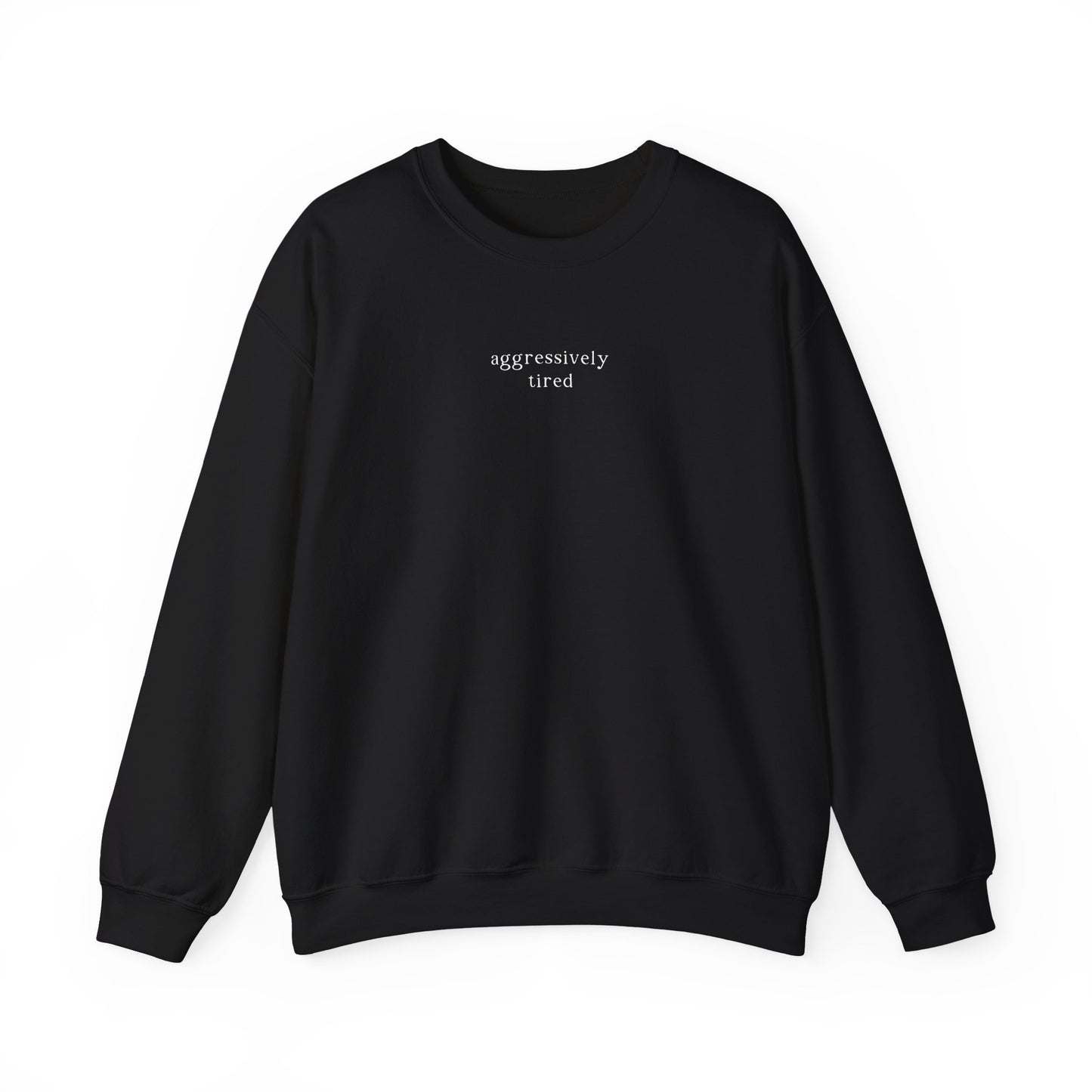 A black oversized sweatshirt featuring minimalist white text across the chest that reads 'aggressively tired'. Clean studio product photography on a white background for the Barely Sane clothing collection.