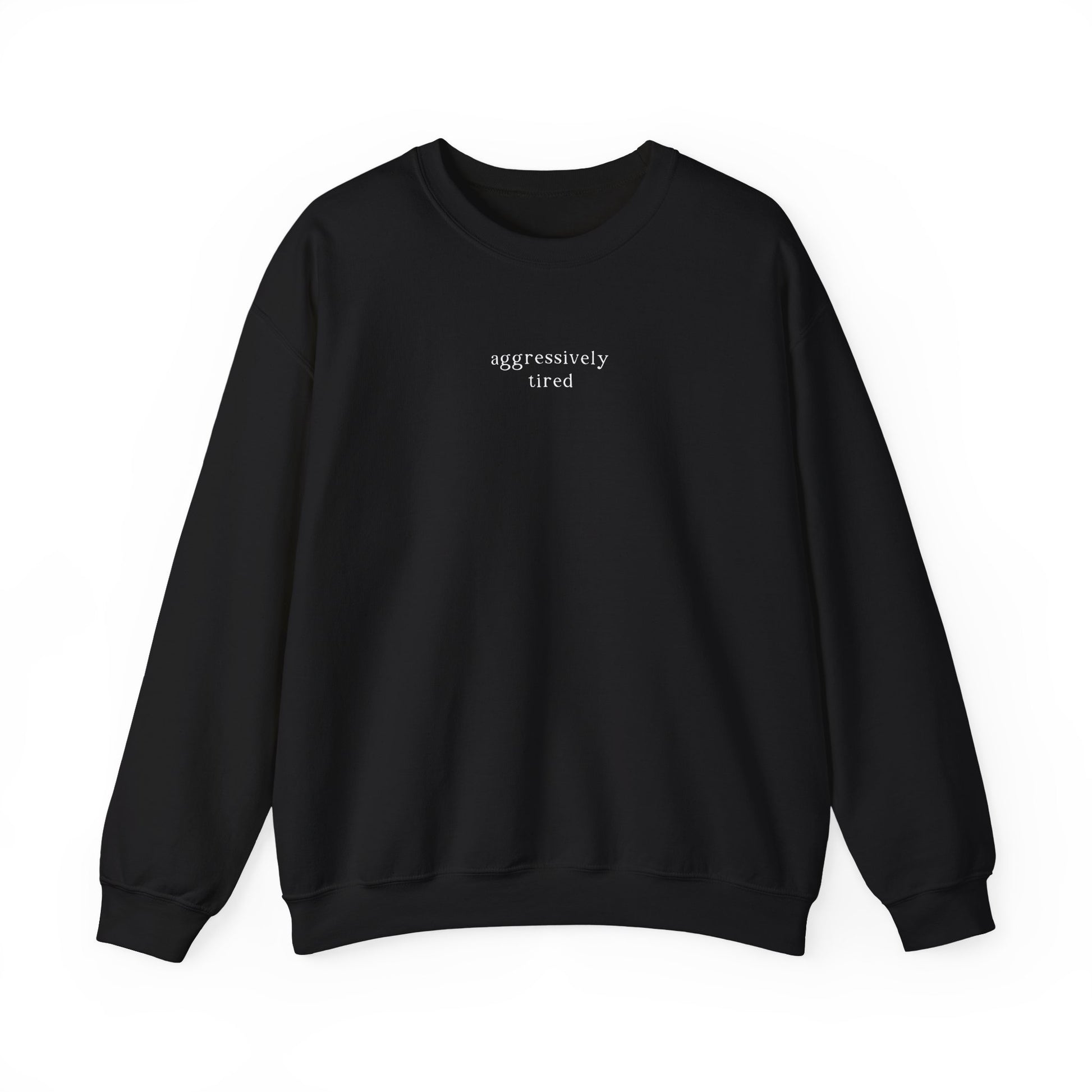 A black oversized sweatshirt featuring minimalist white text across the chest that reads 'aggressively tired'. Clean studio product photography on a white background for the Barely Sane clothing collection.