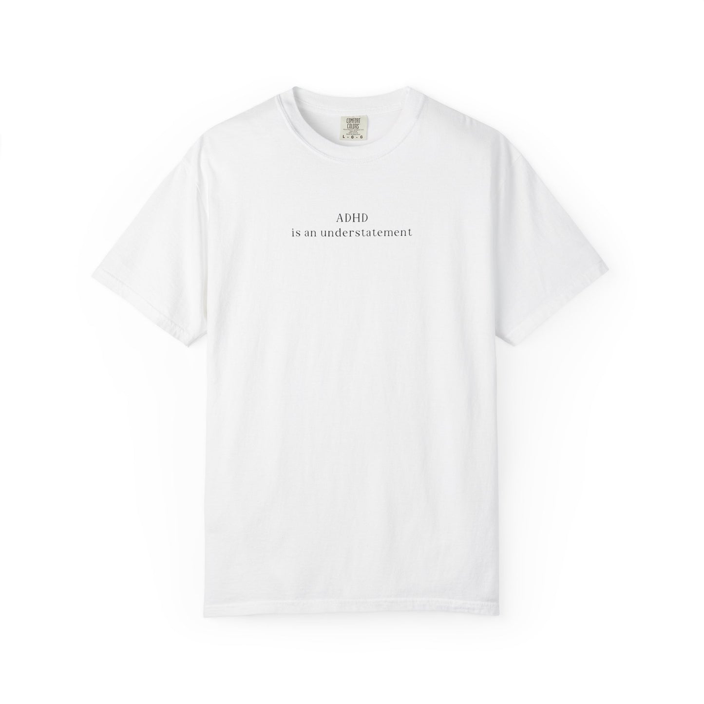 Minimalist white graphic t-shirt featuring the text 'ADHD is an understatement' printed in a small, elegant black font across the chest. Isolated flat lay product shot on a clean white background.