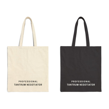 Two "Professional Tantrum Negotiator" canvas bags displayed side by side in Natural and Black colors. Minimalist quote design on durable cotton fabric for relatable parenting style by Barely Sane.